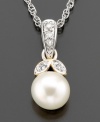 Fresh and joyful, this breathtaking pendant features cultured freshwater pearl (7mm) and diamond accents set in 14k gold and sterling silver. Approximate length: 18 inches. Approximate drop: 1/2 inch.