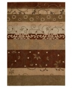 Variegated stripes of earthy tones into warm reds creates a design as artistically moving as it is functional. Hand tufted of long polyester fibers for added strength and softness, the Contour area rug from Nourison creates an ideal accent for any modern room. (Clearance)