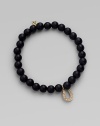 A good luck charm, depicted in diamonds set in 14k yellow gold, hangs from a simple strand of black onyx beads. Diamonds, 0.08 tcw Black onyx 14k yellow gold Diameter, about 2 Charm length, about ½ Stretch cord Imported