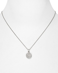 A long, slim chain necklace from Michael Kors. The curvy, concave pendant is decked in glittering pavé crystals for a subtle hint of sparkle.