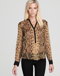 In vibrant viper snake print, this Aqua blouse ensures statement style. Team with your black basics for the office, or pair with denim for weekend brunch. In vibrant viper snake print, this Aqua blouse ensures statement style. Team with your black basics for the office, or pair with denim for weekend brunch.