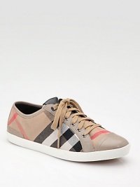 The traditional low-top gets the Burberry treatment in a classic canvas check with leather trim.Lace-up front with signature leather patch Leather toe cap Leather lining and sole Padded insole ImportedOUR FIT MODEL RECOMMENDS ordering true whole size; ½ sizes should order the next whole size down. The traditional low-top gets the Burberry treatment in a classic canvas check with leather trim.Lace-up front with signature leather patch Leather toe cap Leather lining and sole Padded insole ImportedOUR FIT MODEL RECOMMENDS ordering true whole size; ½ sizes should order the next whole size down.