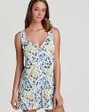 An allover floral print chemise with a flattering V-neckline and pleated back.