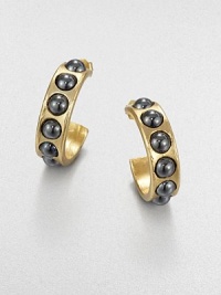 From the Cabochon Collection. Golden hoops dotted with gunmetal-finished natural stones are simple yet striking.Natural stone18k goldplatedDiameter, about .75Post backMade in USA From the Cabochon Collection. Golden hoops dotted with gunmetal-finished natural stones are simple yet striking.Natural stone18k goldplatedDiameter, about .75Post backMade in USA