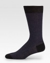 Socks with a classic herringbone pattern and solid ends.80% wool/20% nylonMachine washMade in Italy of imported fabric