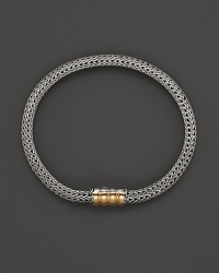 John Hardy sterling silver and gold bracelet with single station. John Hardy sterling silver and gold bracelet with single station.
