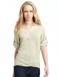 THE LOOKScoop necklinePullover styleThree-quarter length roll tab sleevesPleated detail on chestShirttail hemTHE FITAbout 25 from shoulder to longest point of hemTHE MATERIALViscoseCARE & ORIGINDry clean Made in USAModel shown is 5'10 (178cm) wearing US size 4. THE LOOKScoop necklinePullover styleThree-quarter length roll tab sleevesPleated detail on chestShirttail hemTHE FITAbout 25 from shoulder to longest point of hemTHE MATERIALViscoseCARE & ORIGINDry clean Made in USAModel shown is 5'10 (178cm) wearing US size 4.