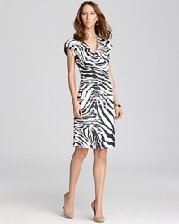 A wild zebra print takes to a tame Lafayette 148 New York sheath for a refined walk on the wild side. A wild zebra print takes to a tame Lafayette 148 New York sheath for a refined walk on the wild side.