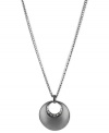 A circular notion. This necklace from Kenneth Cole New York is crafted from silver- and hematite-tone mixed metal with a sculptural circle pendant adorned by glass pave crystal accents shining through. Approximate length: 18 inches + 3-inch extender. Approximate drop: 1-3/4 inches.