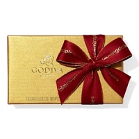 A classic assortment of Belgian chocolates from Godiva comes in a beautiful gold box tied with big red bow and holiday pick. Each ballotin includes Godiva signature favorite ganaches, pralines, caramels, fruits and nuts in milk, dark and white chocolate. A classic assortment of Belgian chocolates from Godiva comes in a beautiful gold box tied with big red bow and holiday pick. Each ballotin includes Godiva signature favorite ganaches, pralines, caramels, fruits and nuts in milk, dark and white chocolate.