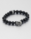 A striking skull pendant of sterling silver accents a stretch beaded bracelet of blue tigers' eye for the modern man of style.Sterling silverTigers' eyeWidth, about 10mmDiameter, about 3Made in USA