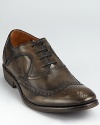 John Varvatos rocks the classic wingtip in style, rendering it in burnished calfskin and soft leather linings.