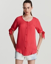 Show off your sweet side in this silk MARC BY MARC JACOBS top with coquettish bow ties at the sleeves. In the season's of-the-moment coral hue with matching buttons through the front, the chic look elevates denim cut-offs for cabana perfection. Show off your sweet side in this silk MARC BY MARC JACOBS top with coquettish bow ties at the sleeves. In the season's of-the-moment coral hue with matching buttons through the front, the chic look elevates denim cut-offs for cabana perfection.