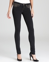 Striking studded front pockets set these black washed True Religion skinny jeans apart from all the rest. Striking studded front pockets set these black washed True Religion skinny jeans apart from all the rest.