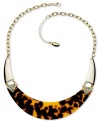 Howl at the moon with this chic crescent-shaped necklace from GUESS. Embellished with sparkling crystal accents and brown tortoise. Crafted in gold tone mixed metal. Approximate length: 16 inches + 2-inch extender. Approximate drop: 1 inch.