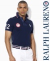 A trim-fitting short-sleeved polo shirt is rendered in breathable cotton mesh with bold country embroidery, celebrating Team USA's participation in the 2012 Paralympic Games.