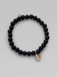 A good luck charm, depicted in diamonds set in 14k yellow gold, hangs from a simple strand of black onyx beads. Diamonds, 0.08 tcw Black onyx 14k yellow gold Diameter, about 2 Charm length, about ½ Stretch cord Imported