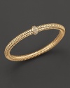 A row of diamonds binds this woven 18K yellow gold bracelet from Roberto Coin.