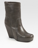 Rich Italian leather with a covered wedge and platform can be paired with a feminine dress or pair of jean shorts. Self-covered wedge, 4 (100mm)Covered platform, 1 (25mm)Compares to a 3 heel (75mm)Leather upperPull-on styleLeather lining and solePadded insoleMade in ItalyOUR FIT MODEL RECOMMENDS ordering one half size up as this style runs small. 