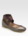 Metallic leather flat held in place by a comfortable, wrap-around strap. Metallic leather and elastic upperLeather lining and solePadded insoleMade in ItalyOUR FIT MODEL RECOMMENDS ordering true size. 