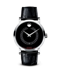 Solid stainless steel frames a black Museum® dial with signature dot at 12 and a unique rotating date disk, with highlighter at 6. Powered by a fine Swiss automatic movement. with exhibition case-back. Finished with an alligator strap. Solid stainless steel frames a black Museum® dial with signature dot at 12 and a unique rotating date disk, with highlighter at 6. Powered by a fine Swiss automatic movement. with exhibition case-back. Finished with an alligator strap.