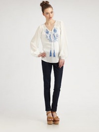 Delicate embroidery highlights airy chiffon in this Moroccan-inspired confection.V neckline with tasselsShirring at shouldersButton half-placketGathered sleevesEmbroidered button cuffsShirttail hemAbout 27 from shoulder to hemRayonDry cleanImportedModel shown is 5'9 (175cm) wearing US size 4. Delicate embroidery highlights airy chiffon in this Moroccan-inspired confection.V neckline with tasselsShirring at shouldersButton half-placketGathered sleevesEmbroidered button cuffsShirttail hemAbout 27 from shoulder to hemRayonDry cleanImportedModel shown is 5'9 (175cm) wearing US size 4.
