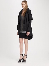 Layered sleeves, asymmetrical zipper and an adjustable back bungee cord add a modern feel to this oversized, lightweight parka with an attached hood. FunnelneckHoodAsymmetrical two-way zipperLong, layered sleevesSingle snap pocketBungee cord at back hemAbout 32 from shoulder to hemPolyesterDry cleanImported of Italian fabricModel shown is 5'10 (177cm) wearing US size Small.