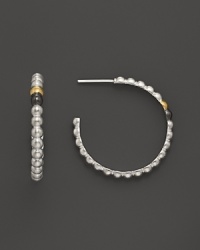 Single 24K gold and dark silver details lend intrigue to Gurhan's sterling silver Cous Cous hoops. Single 24K gold and dark silver details lend intrigue to Gurhan's sterling silver Cous Cous hoops.