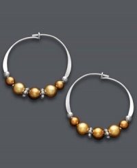 A tri-color blend spices up a traditional pair of hoop earrings. Jody Coyote's unique design offers a metallic mix of copper and gold Austrian crystal pearls threaded onto delicate, sterling silver hoops. Approximate diameter: 3/4 inch. A tri-color blend spices up a traditional pair of hoop earrings. Jody Coyote's unique design offers a metallic mix of copper and gold Austrian crystal pearls threaded onto delicate, sterling silver hoops. Approximate diameter: 3/4 inch.