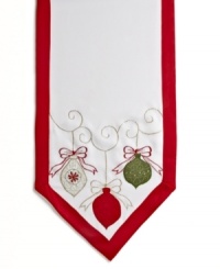 All the trimmings. Prepare for a jolly-good time with the round Holiday Ornaments tablecloth, featuring a simple white cloth festooned with holly embroidery, colorful ornaments and a scalloped edge. All the trimmings. Prepare for a jolly-good time with the round Holiday Ornaments tablecloth, featuring a simple white cloth festooned with holly embroidery, colorful ornaments and a scalloped edge.