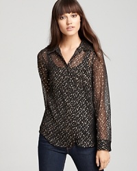 Metallic details lend subtle sparkle to this sheer GUESS top--layer on a cami, dress up your denim and make your mark. Metallic details lend subtle sparkle to this sheer GUESS top--layer on a cami, dress up your denim and make your mark.
