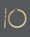 Nothing says classic and cool like the perfect pair of hoops. This trendy style features a unique hammered design on a flat surface. Crafted in 14k gold. Approximate diameter: 1-9/10 inches.