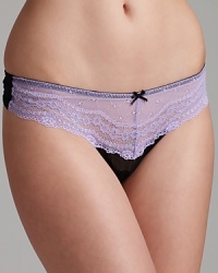 The eyelet lace waistband of Betsey Johnson's low-rise thong lies flat against the body for flattering wear. Style #722325. The eyelet lace waistband of Betsey Johnson's low-rise thong lies flat against the body for flattering wear. Style #722325.