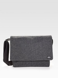 Sturdy and sleek in durable, water resistant waxed wool, detailed with leather trim and custom die-cast black hardware.Adjustable shoulder strapFlap closureLaptop interior pocket with tab closureOrganizing pocketsInterior zipper pocketsCotton liningWaxed wool exterior14 X 14 X 3Imported