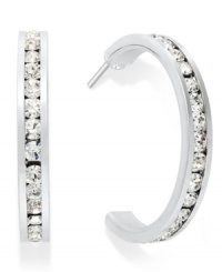 Traditions gives a sparkling boost to a simple pair of hoop earrings. A channel-set row of round-cut clear Swarovski crystals shines within a sterling silver setting. Earrings feature a post and stud backing. Approximate diameter: 3/4 inch. Traditions gives a sparkling boost to a simple pair of hoop earrings. A channel-set row of round-cut clear Swarovski crystals shines within a sterling silver setting. Earrings feature a post and stud backing. Approximate diameter: 3/4 inch.