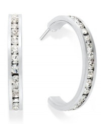 Traditions gives a sparkling boost to a simple pair of hoop earrings. A channel-set row of round-cut clear Swarovski crystals shines within a sterling silver setting. Earrings feature a post and stud backing. Approximate diameter: 3/4 inch.