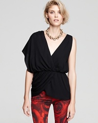 Reveal your inner femme fatale in this dramatically-structured Alice + Olivia Top that flaunts a provocative deep V-neckline and an edgy asymmetric sleeve. Reveal your inner femme fatale in this dramatically-structured Alice + Olivia Top that flaunts a provocative deep V-neckline and an edgy asymmetric sleeve.
