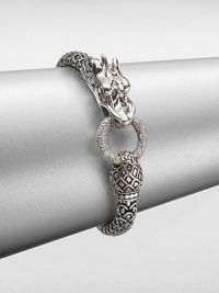 From the Naga Collection. This zodiac-inspired style from a socially and environmentally responsible brand features sterling silver dragon and a brilliant diamond encrusted hoop. Sterling silverDiamonds, .45 tcwLength, about 7.25Hinged clasp closureImported