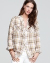 Exuding rustic charm, this Free People plaid shirt boasts cozy knit insets on the back for a cool contrast.