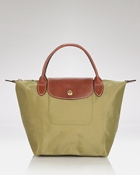 Longchamp's signature nylon tote in a miniature size lends sophisticated chic to every look, from city jaunts to weekend getaways. Folds up for ease during travel. Longchamp's signature nylon tote in a miniature size lends sophisticated chic to every look, from city jaunts to weekend getaways. Folds up for ease during travel.