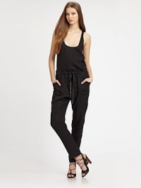 This statement-making one-piece is cinched at the waist by a rich leather drawstring and finished with a skin-baring crossover back.ScoopneckSleevelessBlouson bodiceDrawstring waistSlash pocketsCrossover backRise, about 10Inseam, about 2959% cupro/41% lyocellDry cleanImportedModel shown is 5'10 (177cm) wearing US size 4.