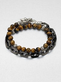 This chain link and beaded, multi-row design of stainless steel and sterling silver is embellished with tiger's eye beading for a colorful, charismatic look.Stainless steel/sterling silverTiger's eyeAbout 3 diam.Imported