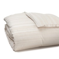 In soft ivory tones, this HUGO BOSS duvet cover creates four-season elegance with a modern linear print texturally woven in cotton jacquard. In soft ivory tones, this HUGO BOSS duvet cover creates four-season elegance with a modern linear print texturally woven in cotton jacquard.