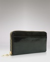 Give into practical accessorizing with this patent Italian leather clutch wallet from Tusk. It's profile is pocket perfect, while a glossy exterior lends polish.