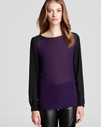 A sheer Sachin + Babi blouse masters exotic-luxe featuring leather, croc-embossed panels at the shoulders for a fashion-forward look inspired by the fall runway. Paired with sleek leggings, the finish is flawless. A sheer Sachin + Babi blouse masters exotic-luxe featuring leather, croc-embossed panels at the shoulders for a fashion-forward look inspired by the fall runway. Paired with sleek leggings, the finish is flawless.