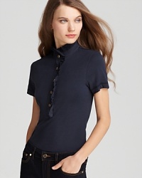 A flirty ruffled neckline lends feminine charm to the classic Tory Burch polo shirt. Pair with white denim for a preppy-chic approach to summer style. A flirty ruffled neckline lends feminine charm to the classic Tory Burch polo shirt. Pair with white denim for a preppy-chic approach to summer style.