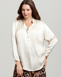 The classic white shirt gets feminine inspiration as subtle shine and rhinestone buttons elevate a fluid Karen Kane Plus blouse. The classic white shirt gets feminine inspiration as subtle shine and rhinestone buttons elevate a fluid Karen Kane Plus blouse.