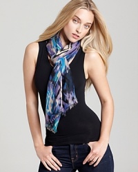 A bohemian oblong scarf with colorful ikat print and self fringe edges. A bohemian oblong scarf with colorful ikat print and self fringe edges.