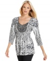 A sparkling beaded applique at the neck elevates this Style&co. top while a sublimated animal print adds an edgy spin.