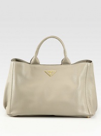 Rich leather in a top-handle silhouette with logo detail.Double top handles, 5¾ dropProtective metal feetOne inside zip pocketThree inside open pocketsPrada logo lining16¾W X 10½H X 9¼DMade in Italy Rich leather in a top-handle silhouette with logo detail.Double top handles, 5¾ dropProtective metal feetOne inside zip pocketThree inside open pocketsPrada logo lining16¾W X 10½H X 9¼DMade in Italy